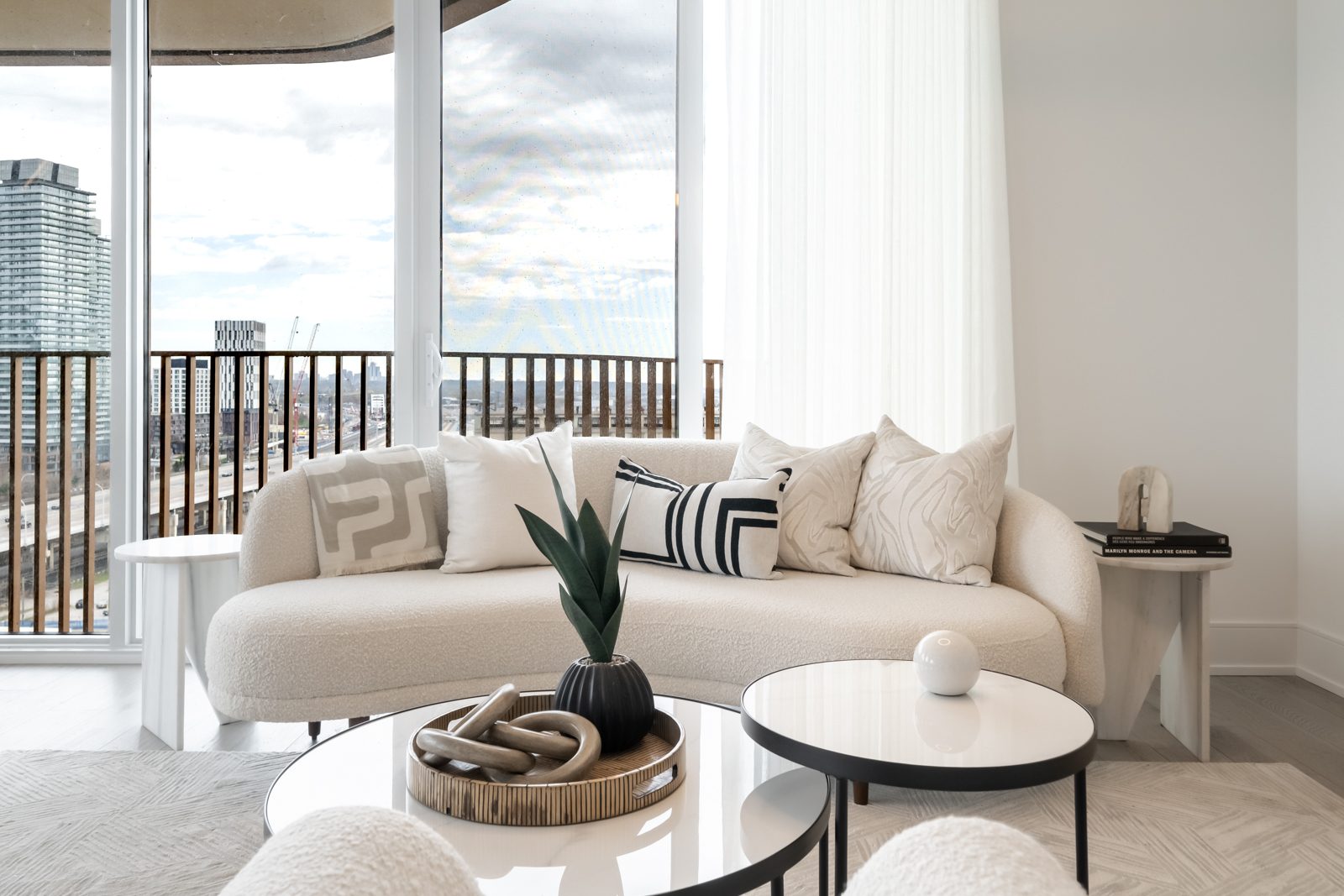 Curved sofa in front of windows overlooking the city